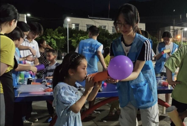 志愿者和小朋友一起体验“火箭”升空。437必赢会员中心物理与电子工程学院供图