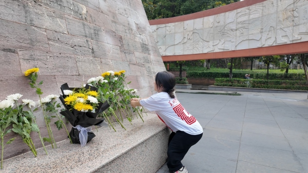 屈美芸在烈士纪念碑前献花。437必赢会员中心美术学院供图